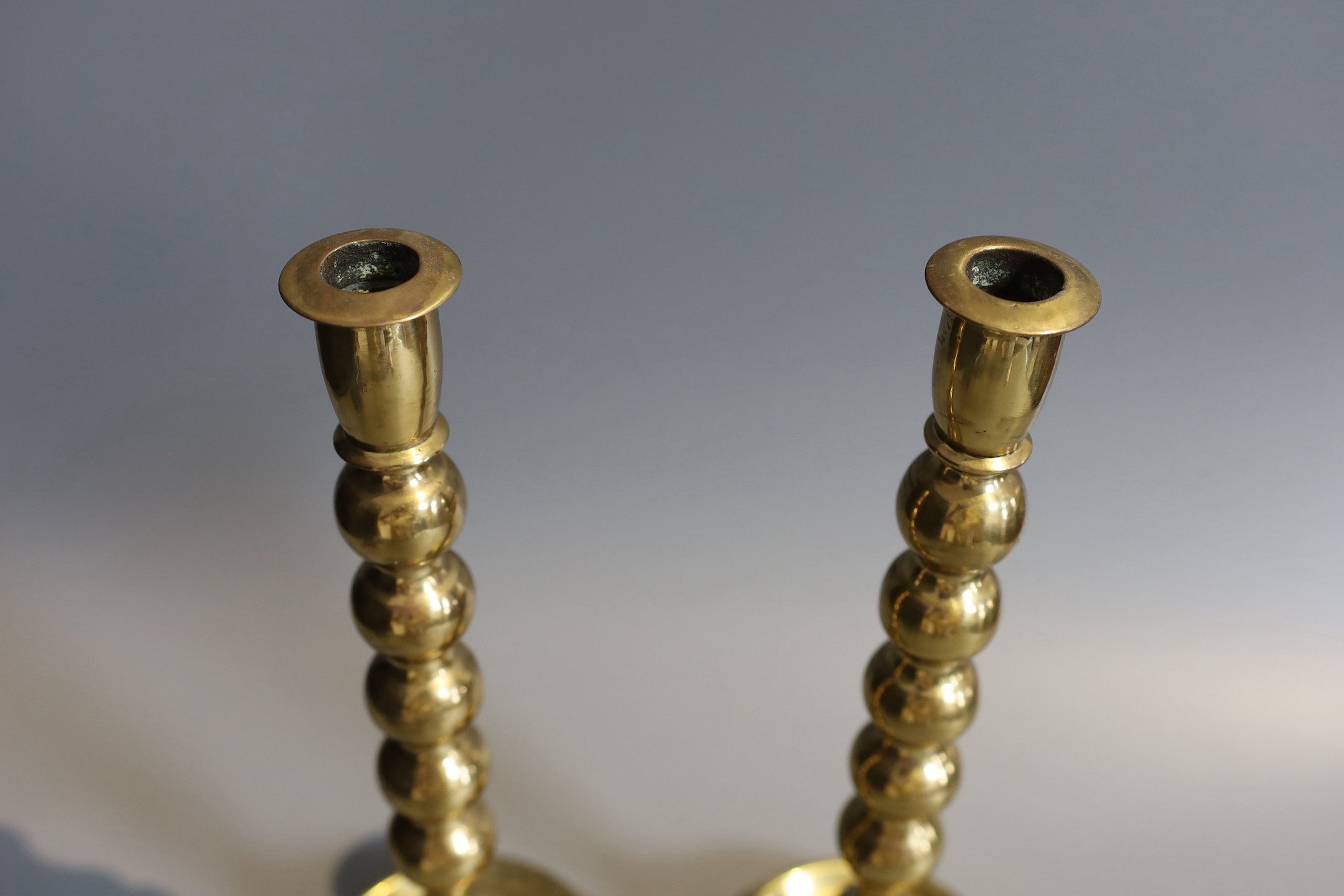 A pair of Victorian brass ejector candlesticks, with bobbin stems, height 31cm